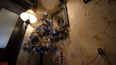 Christmas Tree decorative pine branches with lights. Family house interior. 動画素材 129821549
