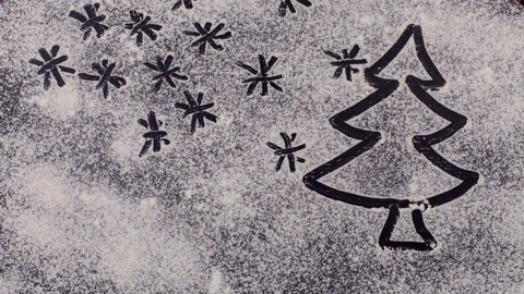 Christmas tree drawing appears in a flour layer on table Stock Footage 82781291