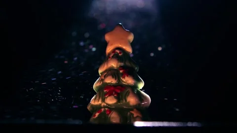 Christmas tree figurine in a ray of light Stockbeeldmateriaal 258838192