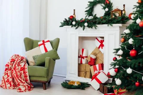 Christmas tree with fireplace interior of the house new year decor gifts Stock Photos
