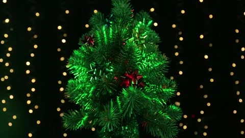 Christmas tree with a flying animation of light rotates on a black background Stock Footage 246852875