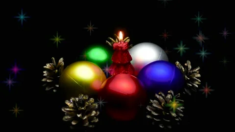 A Christmas tree in the form of a burning candle is spinning on a stand Stock Footage 165090133