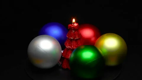 A Christmas tree in the form of a burning candle is spinning on a stand Stock Footage 165090175