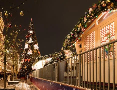 Christmas tree in front of the building on the background of decorated houses Stock Photos