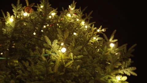 Christmas tree with garland on a black background Stock Footage 265087052