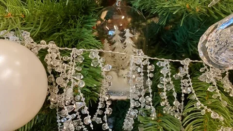 Christmas tree garland hanging on a Christmas tree. Glass garland Stock Footage