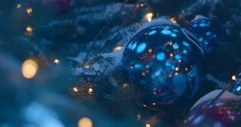 Christmas tree with a garland of large mirror balls who reflects lights Stock Footage 119545319