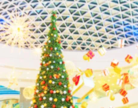 Christmas tree with gift boxes and decorations suspended from the ceiling Stock Photos