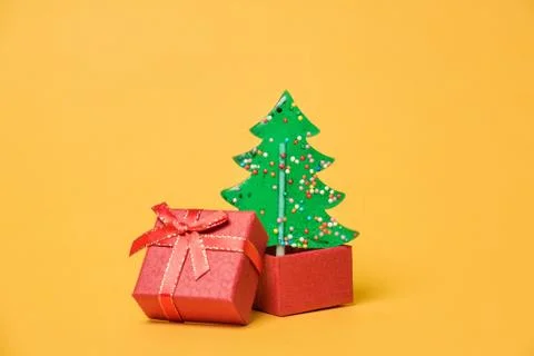 A Christmas tree grows from an open gift box. Stock Photos