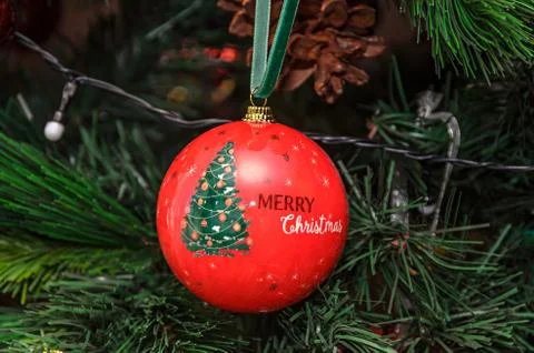 Christmas tree hanging ornament, red globe with write merry christmas, close  Stock Photos