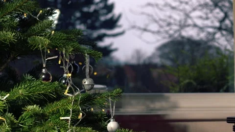 Christmas tree in home in front of window with baubles and candy cane Video stock 259068313