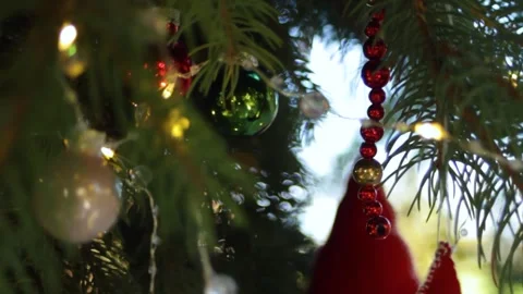 The Christmas tree is hung with Christmas decorations and lighted garlands. A Stock Footage 296402017