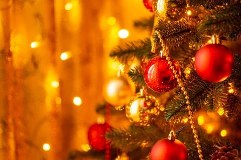 Christmas tree illuminated by bright warm electric garland lights Stock Photos
