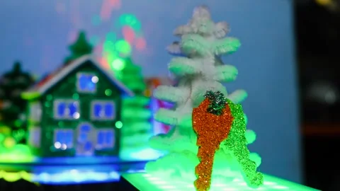 Christmas tree with keys moves against the background of rotating colored houses Video stock 305601430