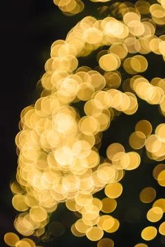 A christmas tree with lights in the background Stock Photos