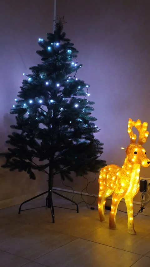Christmas tree with lights, dim light and glowing deer Stock Footage 322665466