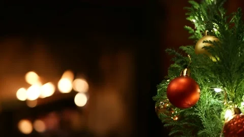Christmas tree lights by fire in fireplace, New Year or Xmas decoration of pine. Stock Footage 158917111
