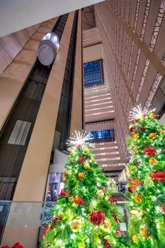 Christmas tree lights inside a modern building with elevators. H Stock Photos