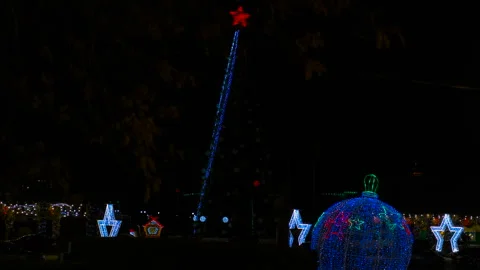 Christmas tree lights turning on, creating a festive atmosphere Stock Footage 319094976