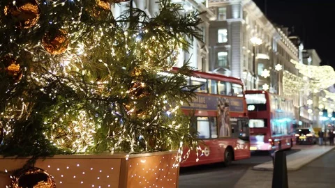 Christmas tree in London at night with London buses behind Stock Footage
