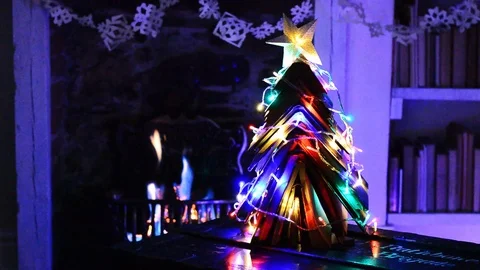 Christmas tree made from books with fire and lights. Stock Footage 88542218