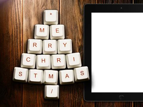 Christmas tree made of computer keys and tablet computer on wooden background Stock Illustration
