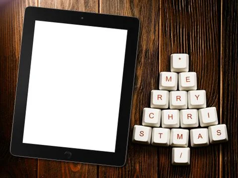 Christmas tree made of computer keys and tablet computer on wooden background Stock Illustration