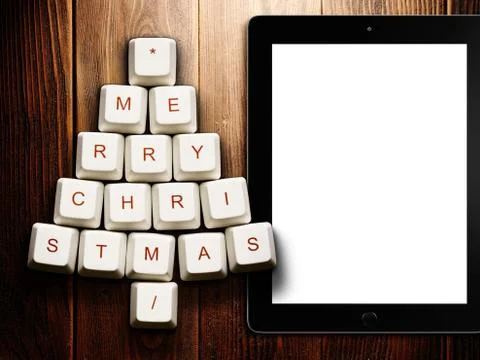 Christmas tree made of computer keys and tablet computer on wooden background Stock Illustration