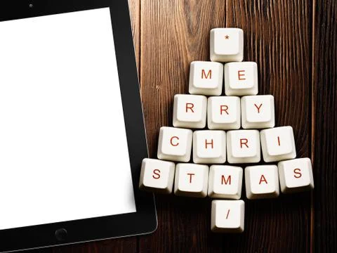 Christmas tree made of computer keys and tablet computer on wooden background Stock Illustration