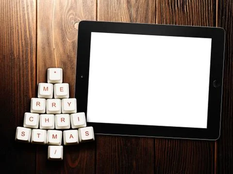 Christmas tree made of computer keys and tablet computer on wooden background Stock Illustration