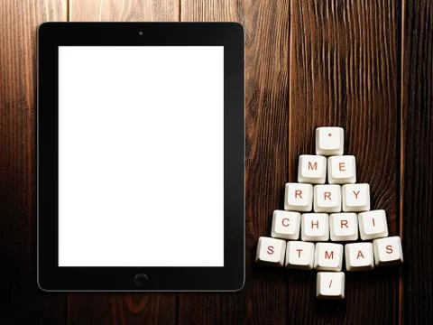 Christmas tree made of computer keys and tablet computer on wooden background Stock Illustration