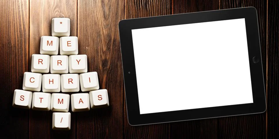 Christmas tree made of computer keys and tablet computer on wooden background Stock Illustration