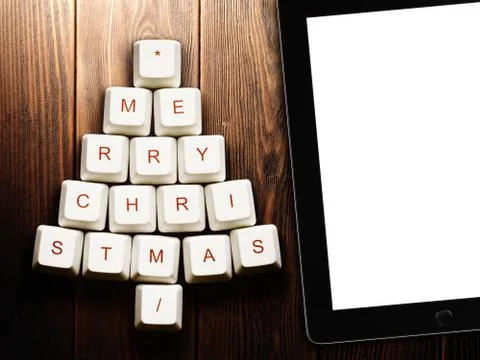 Christmas tree made of computer keys and tablet computer on wooden background Stock Illustration