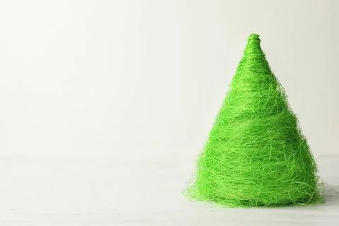 Christmas tree made of green threads on table against white background, space Stock Photos