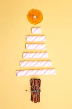 Christmas tree made of marshmallow candy, dried orange and cinnamon sticks on Stock Photos