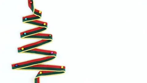 Christmas tree made of multi-colored ribbon on a white background. Stock Photos