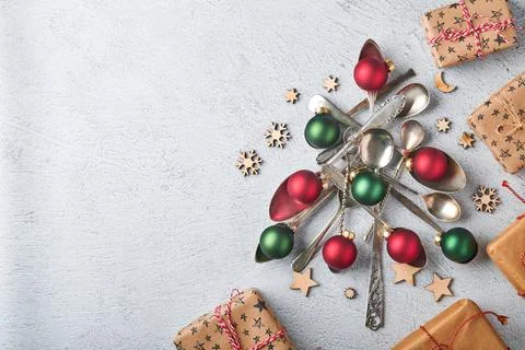 Christmas tree made from old spoons or cutlery with red and green Christmas b Stock Photos