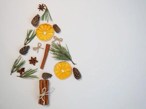 Christmas tree made of pine branches, cones, dried orange circles, star anise Stock Photos