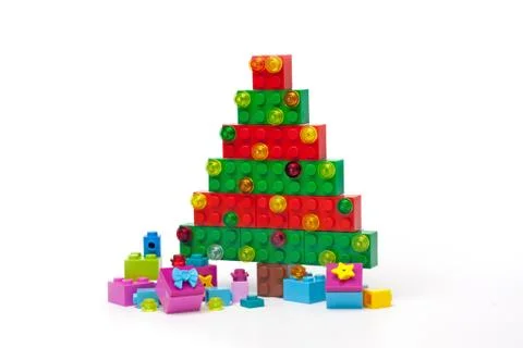 Christmas tree made of plastic bricks on white background Foto stock