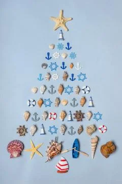 Christmas tree made of various seashells, sea stars, decorative items and min Stock Photos