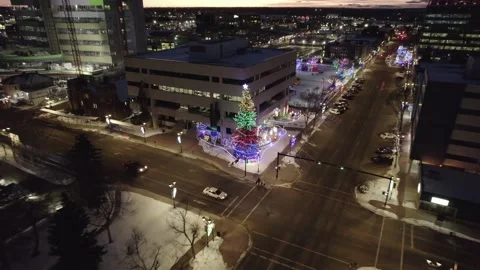 Christmas Tree in the middle of city surrounded with buildings and architectures Stock Footage 221807840