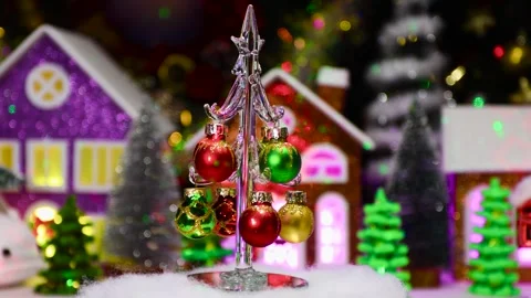 A Christmas tree moves against the backdrop of a large Christmas town Stock Footage 294682925