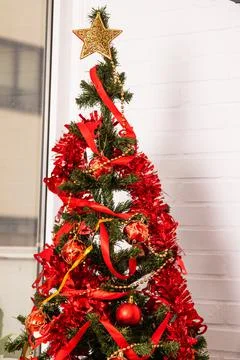 Christmas tree with objects and red decoration Stock Photos