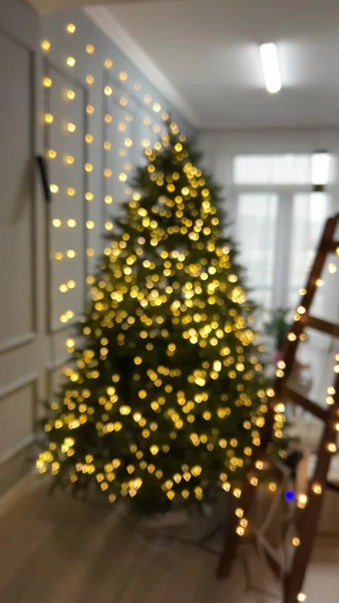 Christmas tree is out of focus. Blurred background with golden bokeh lights Stock Footage 256041629
