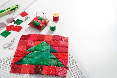 Christmas tree patchwork block, bright square pieces of fabric, pincushion,.. Stock Photos