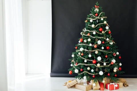 Christmas tree pine black interior room new year decor garland gifts postcard 스톡 사진
