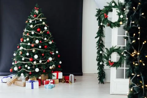 Christmas tree pine black interior room new year decor garland gifts postcard Stock Photos