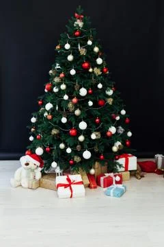 Christmas tree pine black interior room new year decor garland gifts postcard Stock Photos