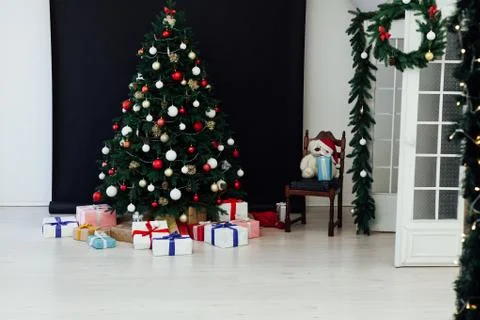 Christmas tree pine black interior room new year decor garland gifts postcard Stock Photos