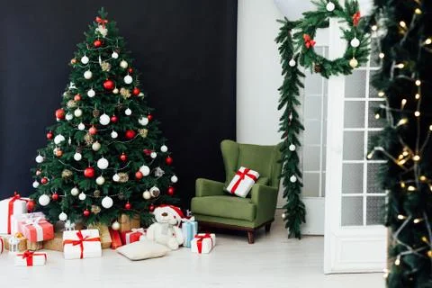 Christmas tree pine black interior room new year decor garland gifts postcard Stock Photos
